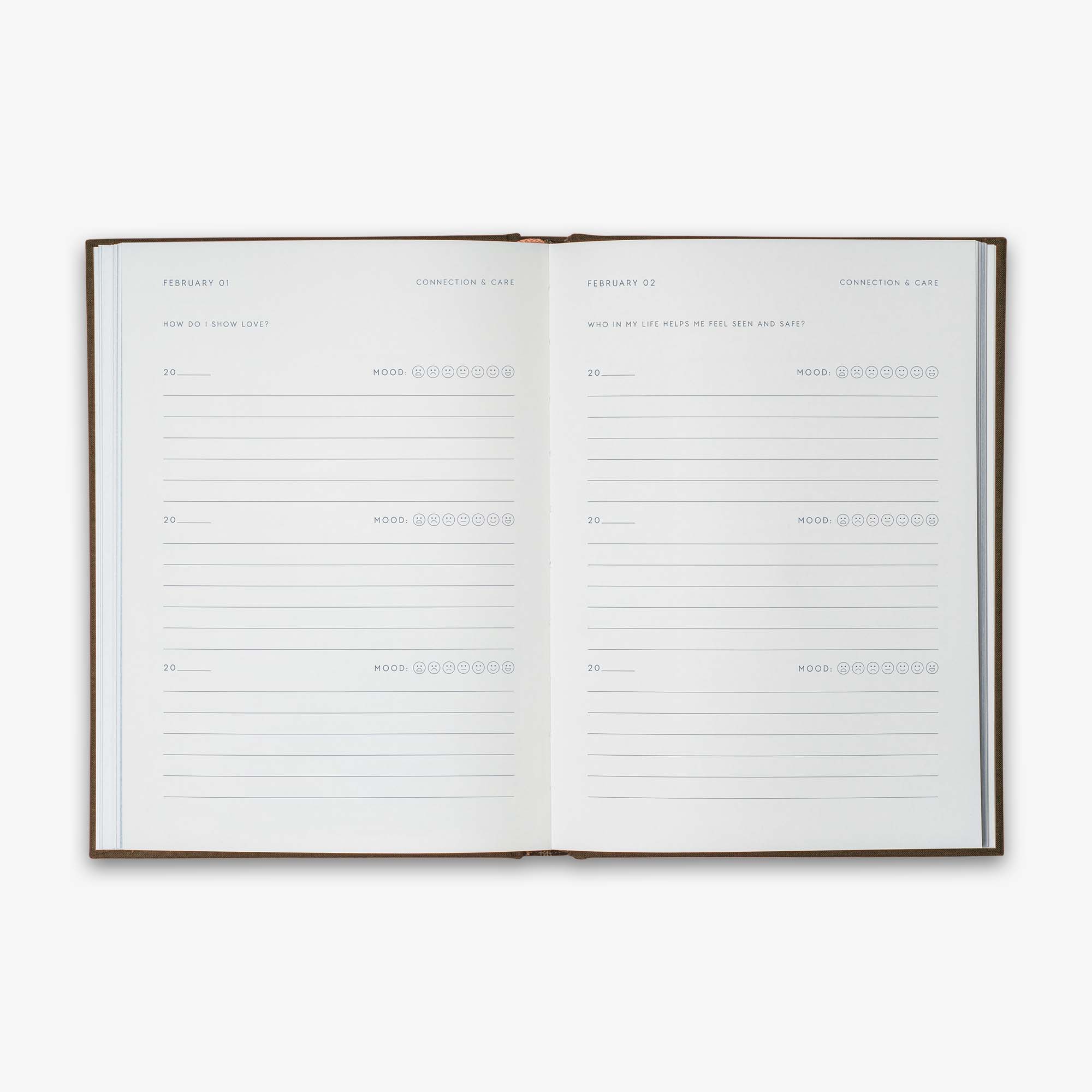 Open book from our Three Year Journal with the daily prompts on a white background