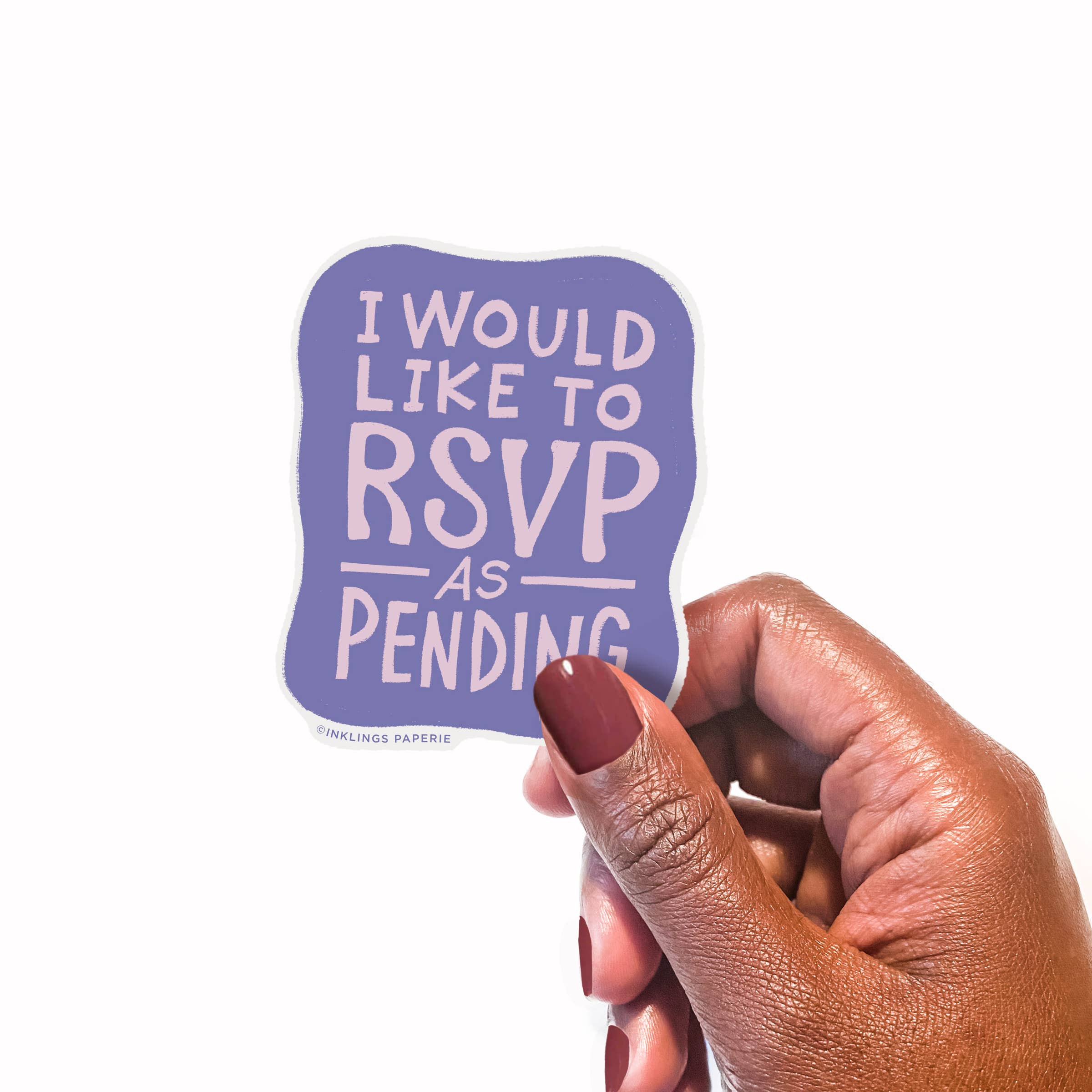 Hand holding a purple vinyl sticker with 'I would like to RSVP as pending' text on a white background