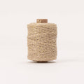 Spool of beige thread on a white background