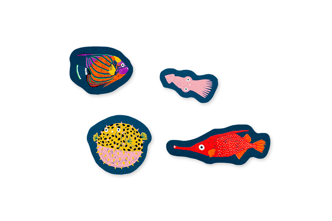 Four colorful fish stickers on a white background