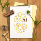 Easter-themed card with stamps on a wooden surface