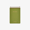 Green notebook with spiral binding on a white background