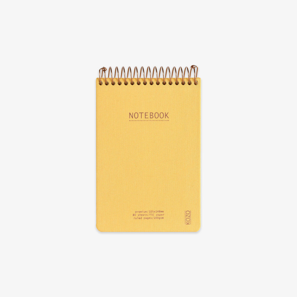 Yellow notebook with spiral binding on a white background