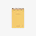 Yellow notebook with spiral binding on a white background