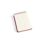Small notebook with a red binding on a white background