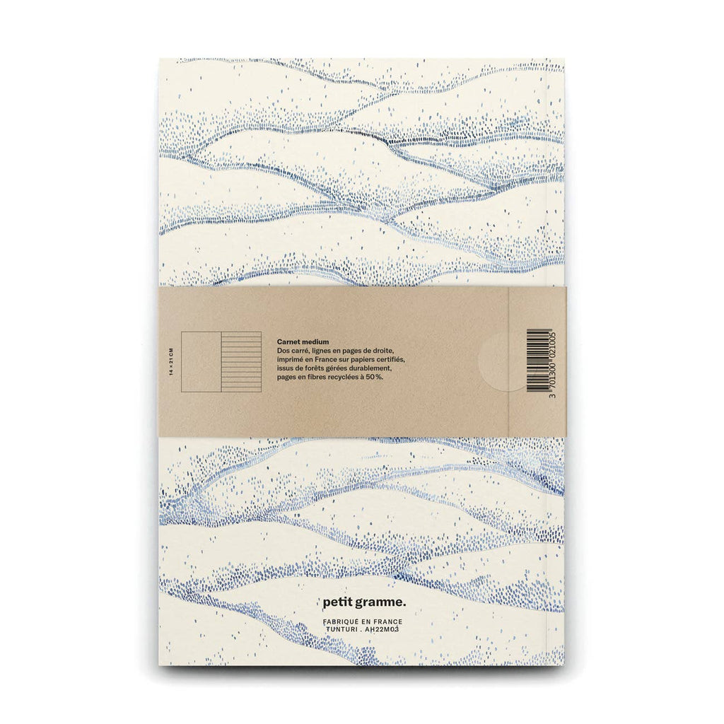 Notebook with wave pattern and Petit Gramme branding on a white background