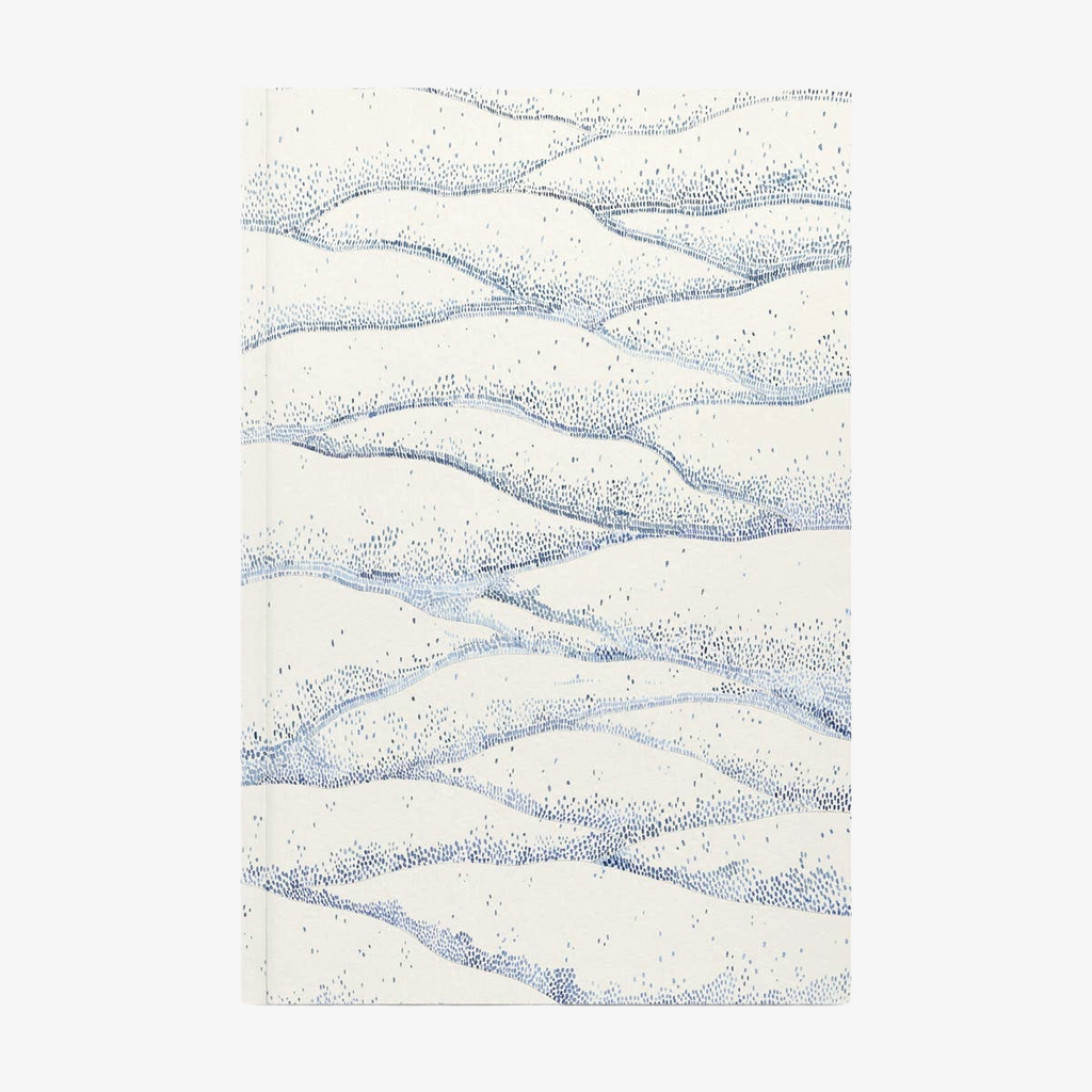 Softcover notebook with wavy blue pattern on a white background