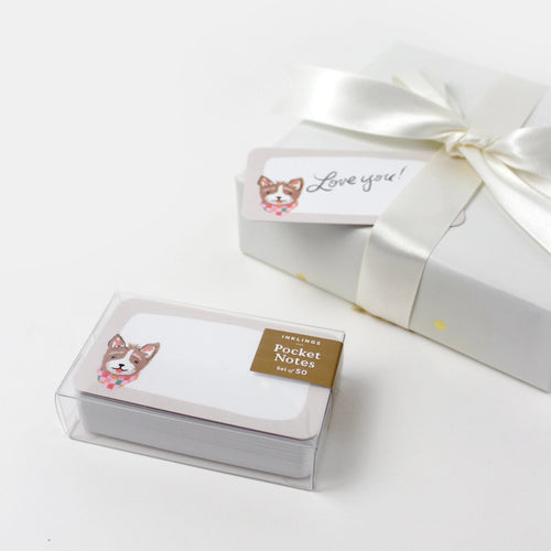 Pocket notes with dog illustration in a clear box on a white background