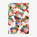 A softcover notebook with a colorful watercolor floral pattern on an off-white cover, shown against a plain white background.
