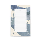 Notepad with blue and beige leaf pattern on a white background