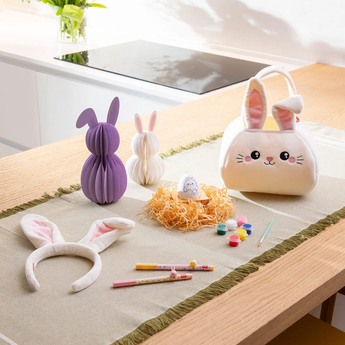 Set of rabbit-themed items including a small bag, headbands, and stationery from Legami Milano on a table.