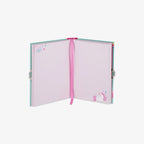 Open notebook with a pink ribbon with unicorn design on a white background