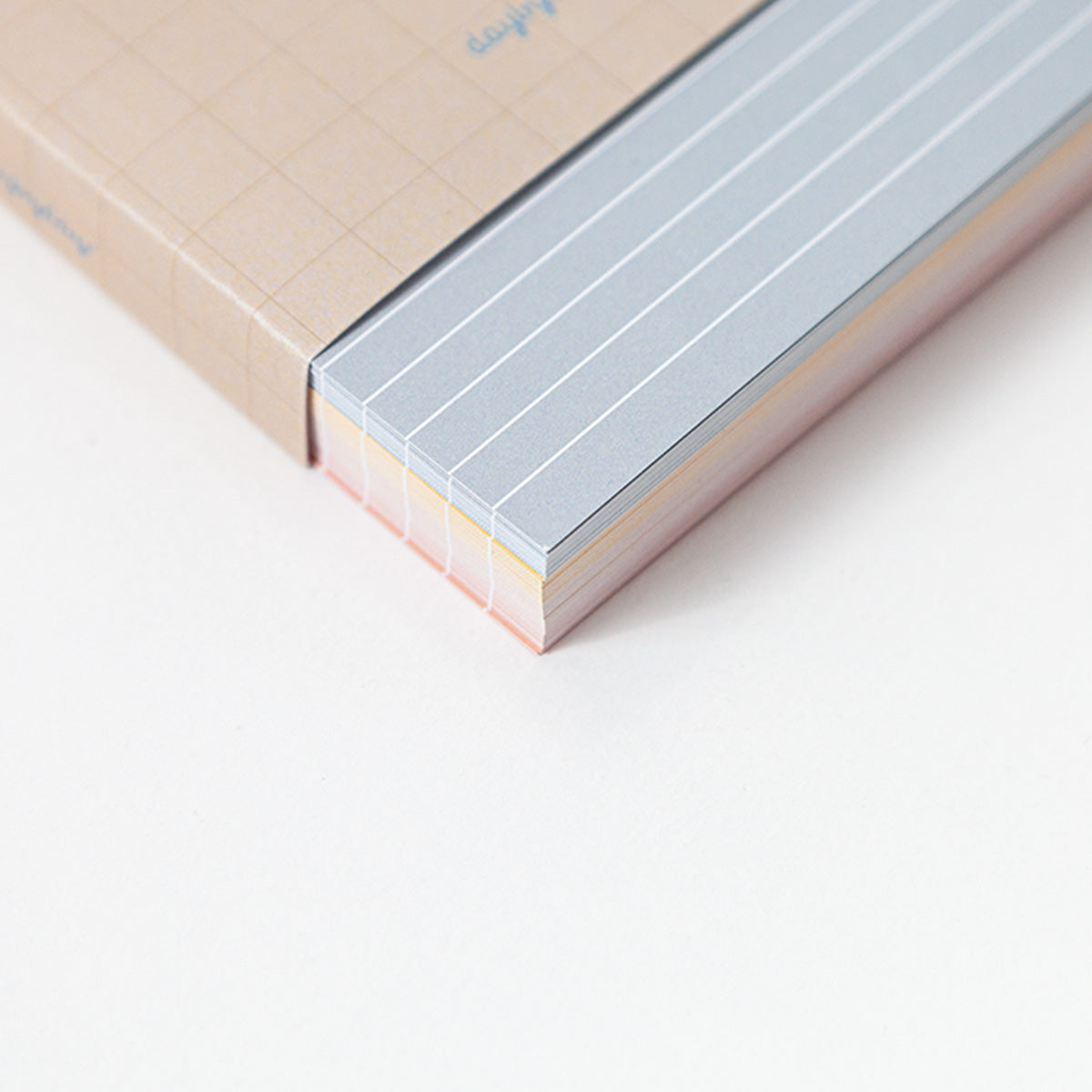 Close-up of a memo card with lined pages on a light background