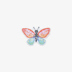Colorful butterfly-shaped vinyl sticker with 'spread your wings' text on a white background