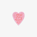 Pink heart-shaped vinyl sticker with 'Spread Love Wherever You Go' text on a white background