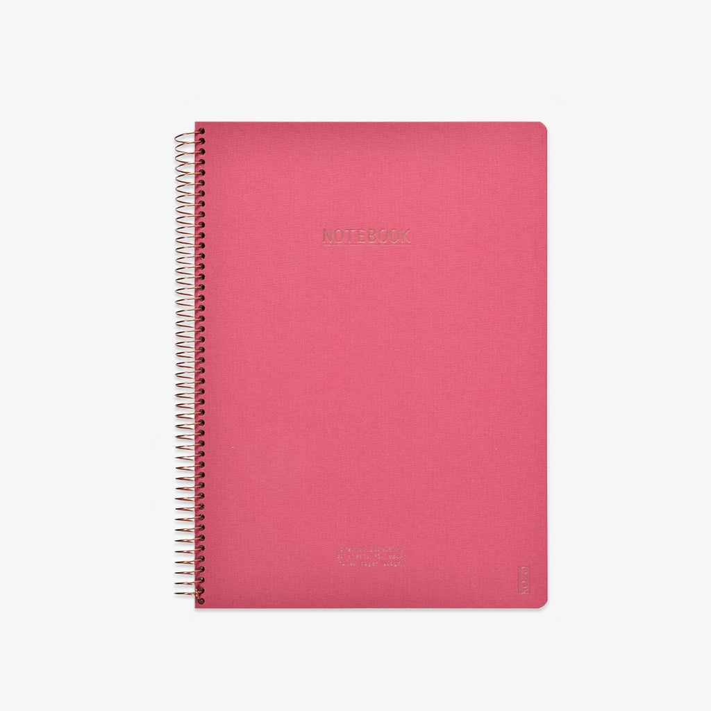 Pink notebook with spiral binding on a white background