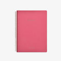 Pink notebook with spiral binding on a white background