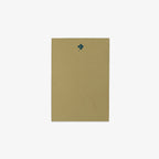 Green notepad with a dark green clover design on a white background