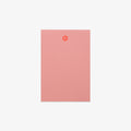 Pink notebook with a paw print design on a white background