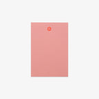 Pink notebook with a paw print design on a white background