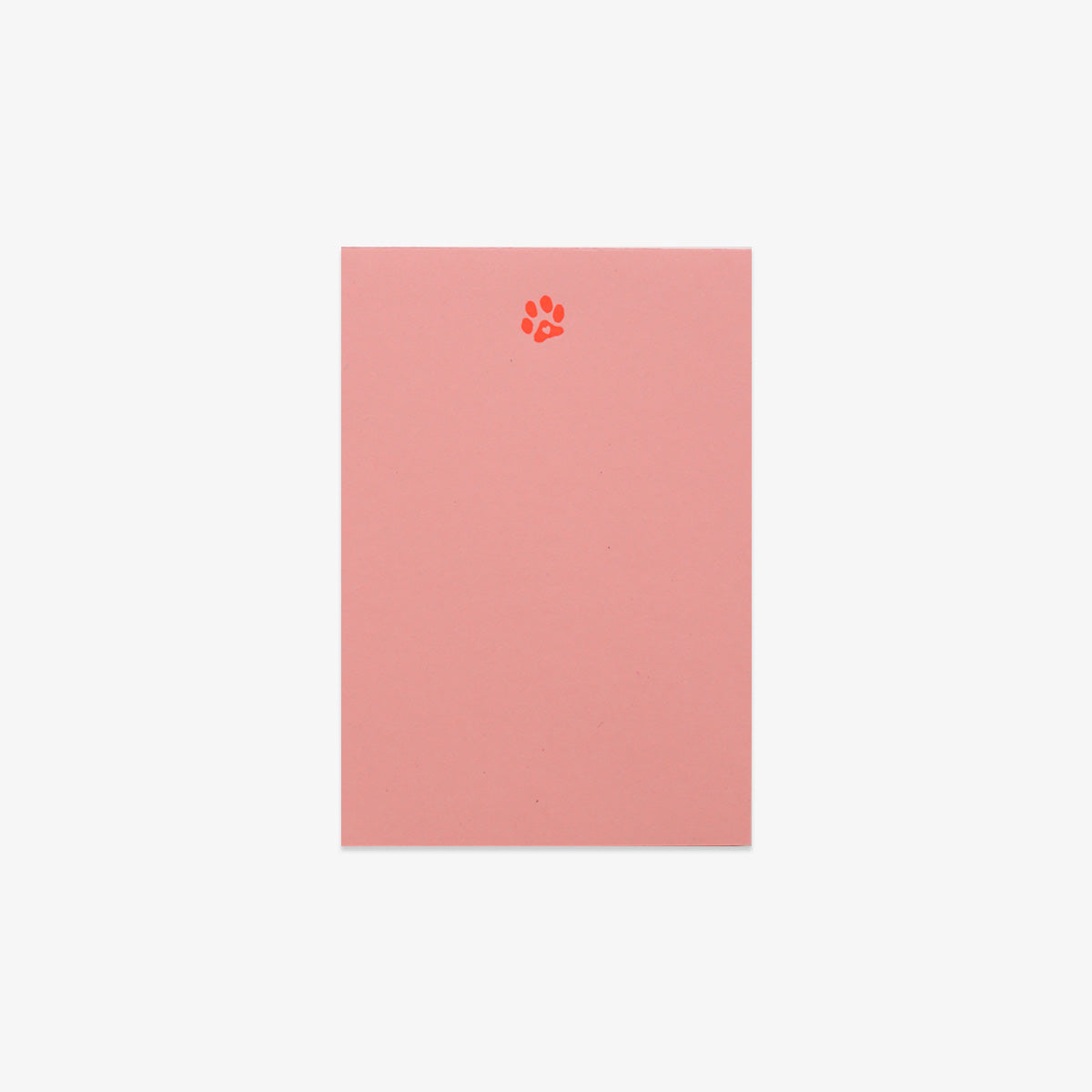 Pink notebook with a paw print design on a white background