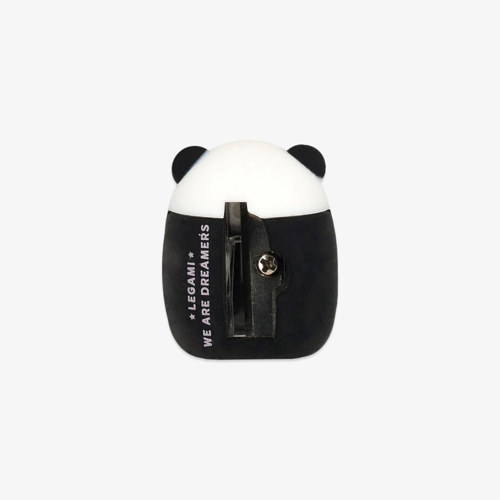 Panda-shaped pencil sharpener with black and white design on a light gray background