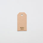 Kraft gifttag with 'MERRY XMAS' text on a light gray background