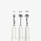 Three pen tips with black ink drawing flowers with different sizes.