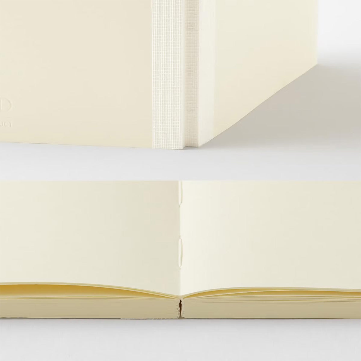 Open notebook with cream-colored pages on a light gray background