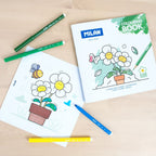 Coloring book with flowers and coloring pencils on a wooden surface
