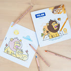 Milan coloring book with lion illustrations and colored pencils on a wooden surface
