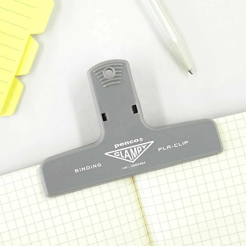 Grey clamp holding a journal