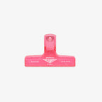 Pink binding clip on a white background