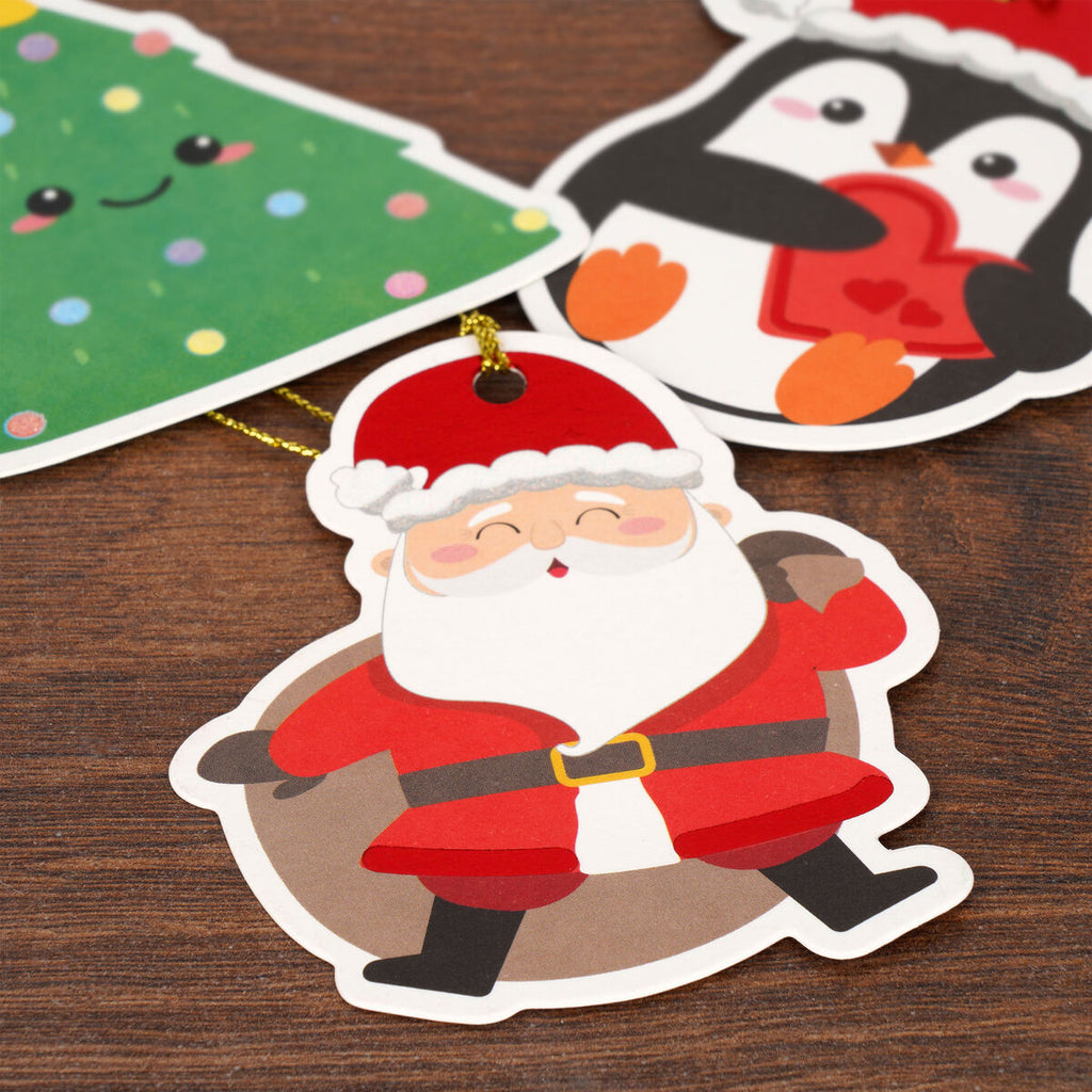 Cartoon Santa Claus gift tag on a wooden surface with other Christmas-themed stickers.