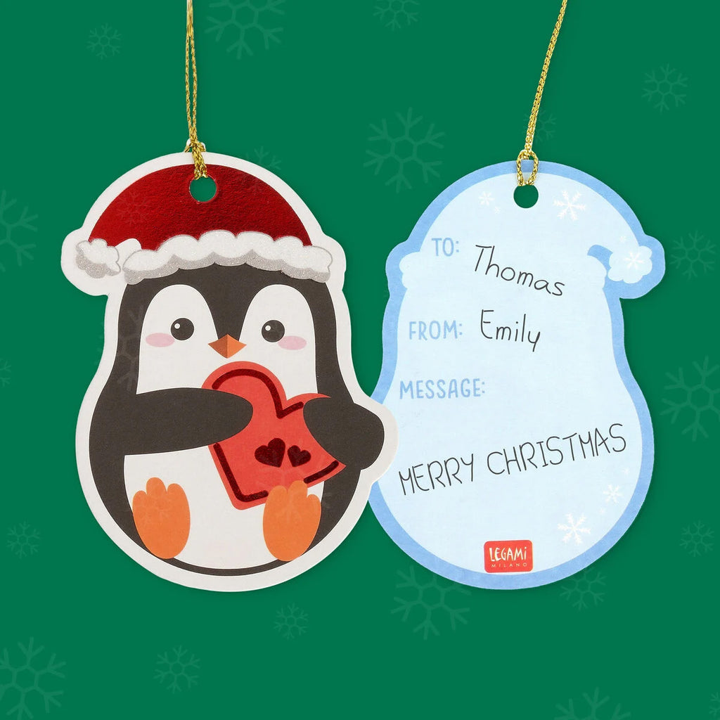 Christmas gift tag with a penguin holding a heart and a tag on a green background