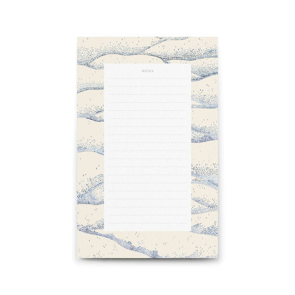 Notepad with blue and white abstract design on a white background