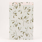 Packaging with a green leaf pattern on a light background