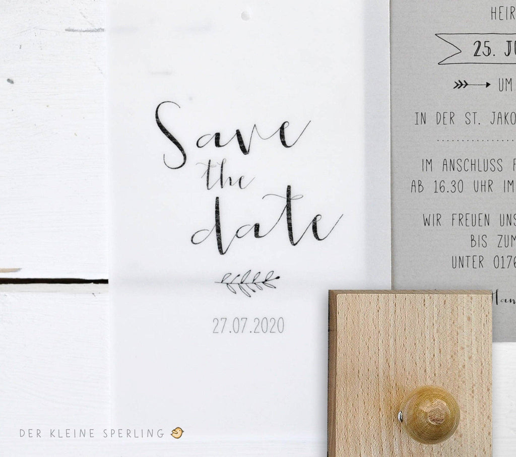 Save the date card with text and a small decorative element on a white background.