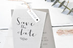 Save the date card with a tag on a white background